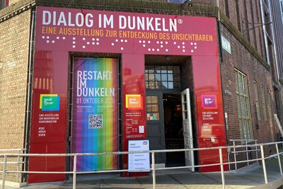 Photo of the entrance of the Dialoghaus in Hamburg decorated with rainbow colored banners that announce the re-opening on October, 1st.